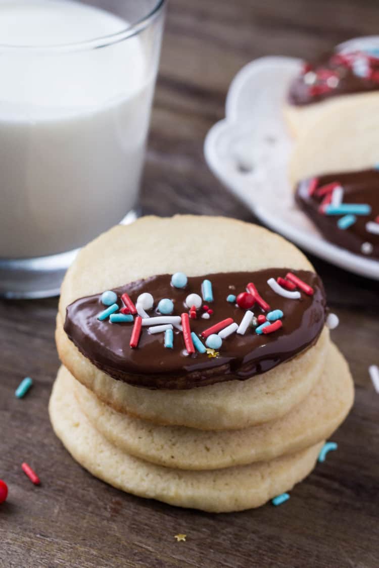 These easy chocolate dipped icebox cookies are the perfect make-ahead recipe for the holidays. Soft, buttery, dipped in chocolate & decorated with sprinkles.