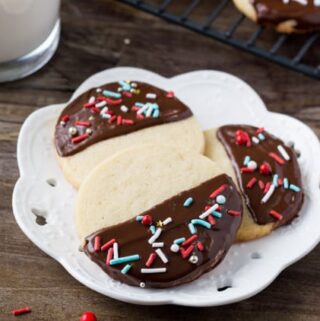 These easy chocolate dipped icebox cookies are the perfect make-ahead recipe for the holidays. Soft, buttery, dipped in chocolate & decorated with sprinkles.
