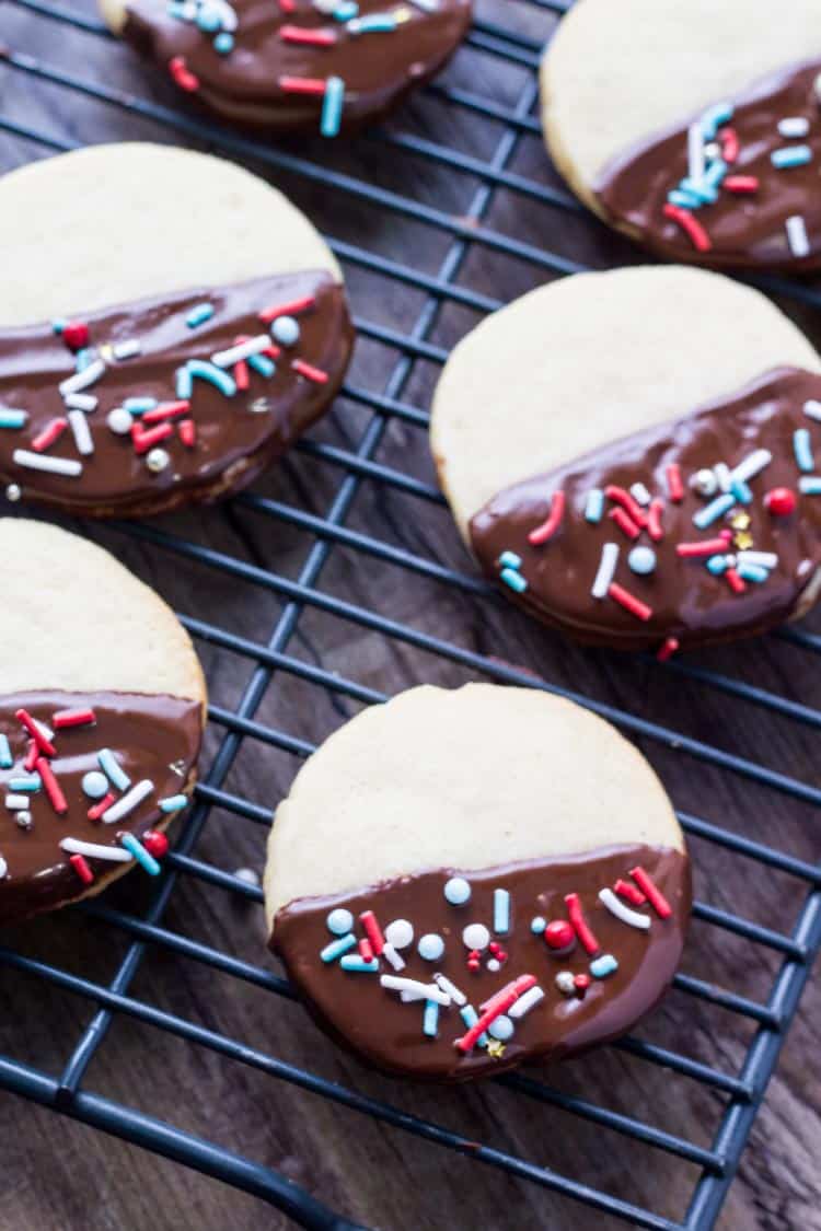 These easy chocolate dipped icebox cookies are the perfect make-ahead recipe for the holidays. Soft, buttery, dipped in chocolate & decorated with sprinkles.