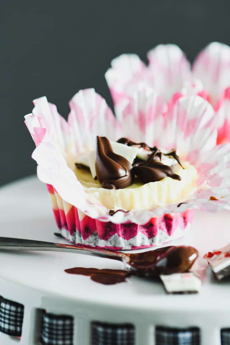 Peppermint Bark Mini Cheesecakes are perfect for any holiday gathering! Make this delicious dessert for your next party or for a family dessert. #cheesecake #holidayrecipes #sweettreats