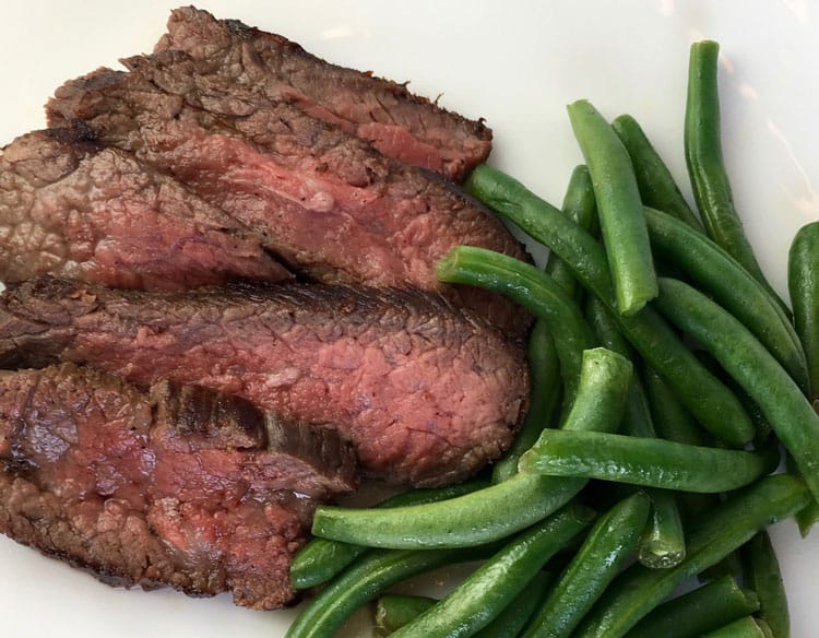 steak and green beans on white plate