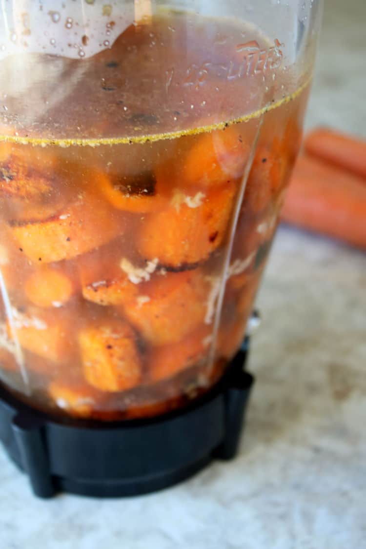 roasted carrots with vegetable broth in blender sitting on counter