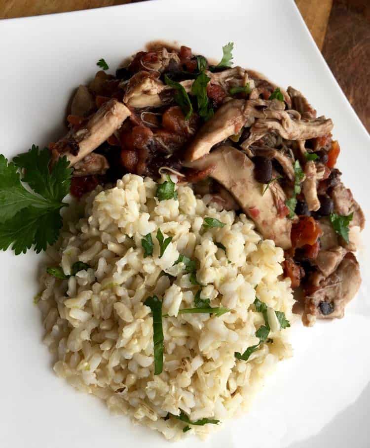 cilantro rice and chicken on white plate