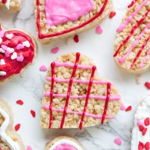 These Valentine's Rice Krispie treats are an easy, fun & festive recipe for February 14th. Kids will love making them, and they're a perfect treat to bring to school or Valentine's day parties.