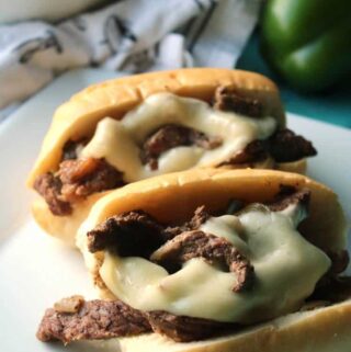 easy philly cheesesteak sandwiches on rolls with provolone cheese