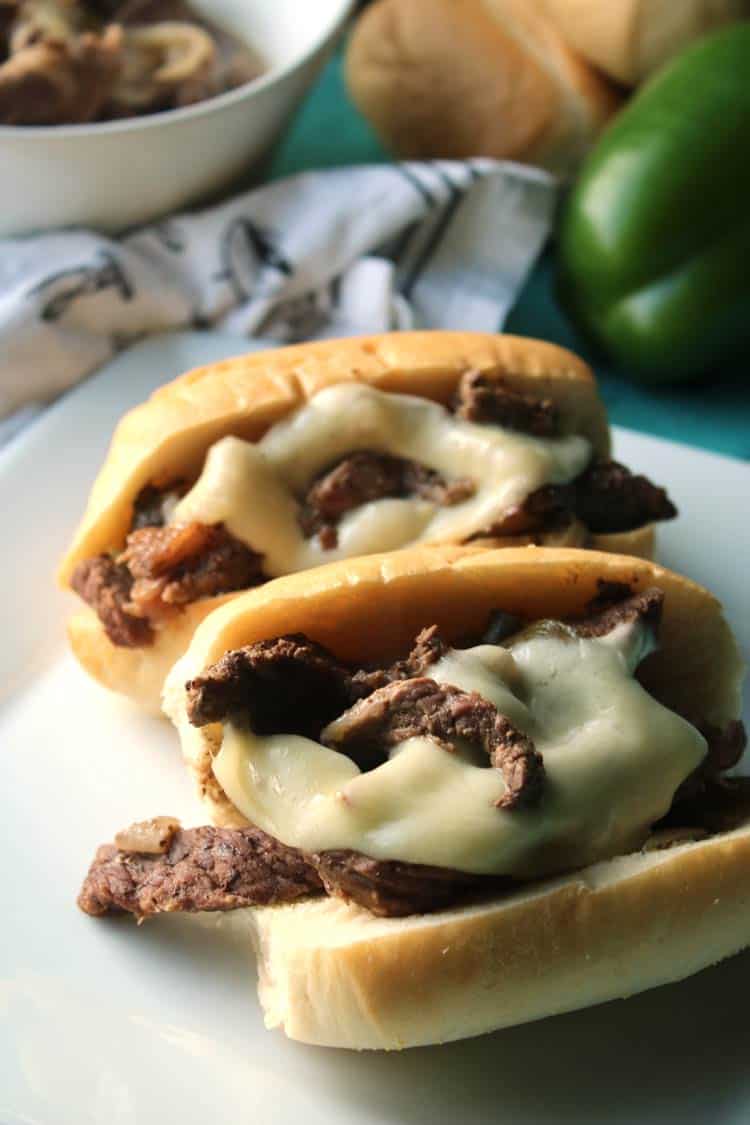easy philly cheesesteak sandwiches on rolls with provolone cheese