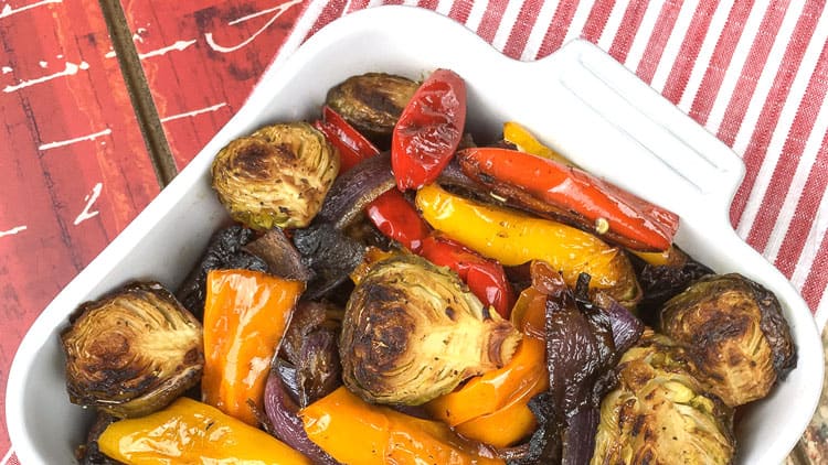 overhead view of Mediterranean roasted vegetables in white baking dish