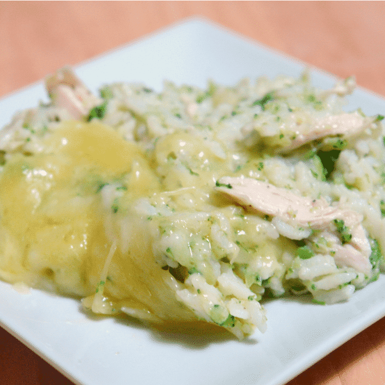 closeup of Chicken, broccoli, and rice casserole on a white square plate on table