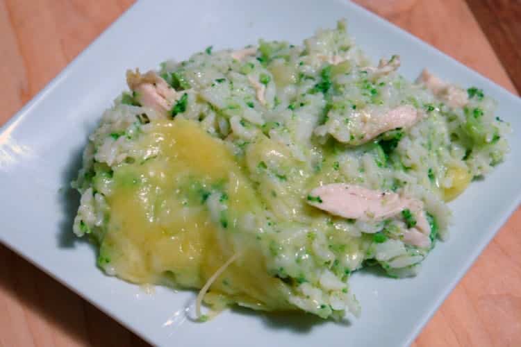 serving of Chicken, broccoli, and rice casserole on a white plate on a dinner table