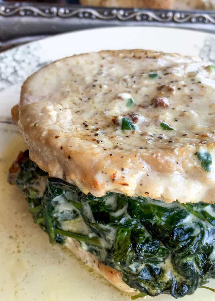 keto pork chops stuffed with spinach and smothered in a creamy sauce