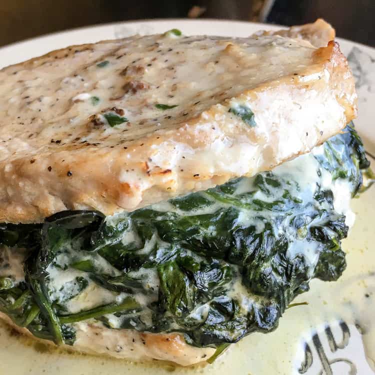 closeup of keto pork chops with spinach and sour cream stuffed in middle