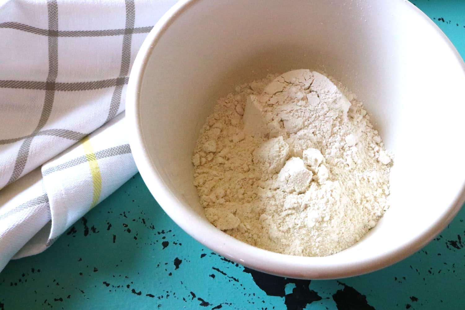 Mexican Corn Bread Step 1 corn meal and white flour in white bowl.