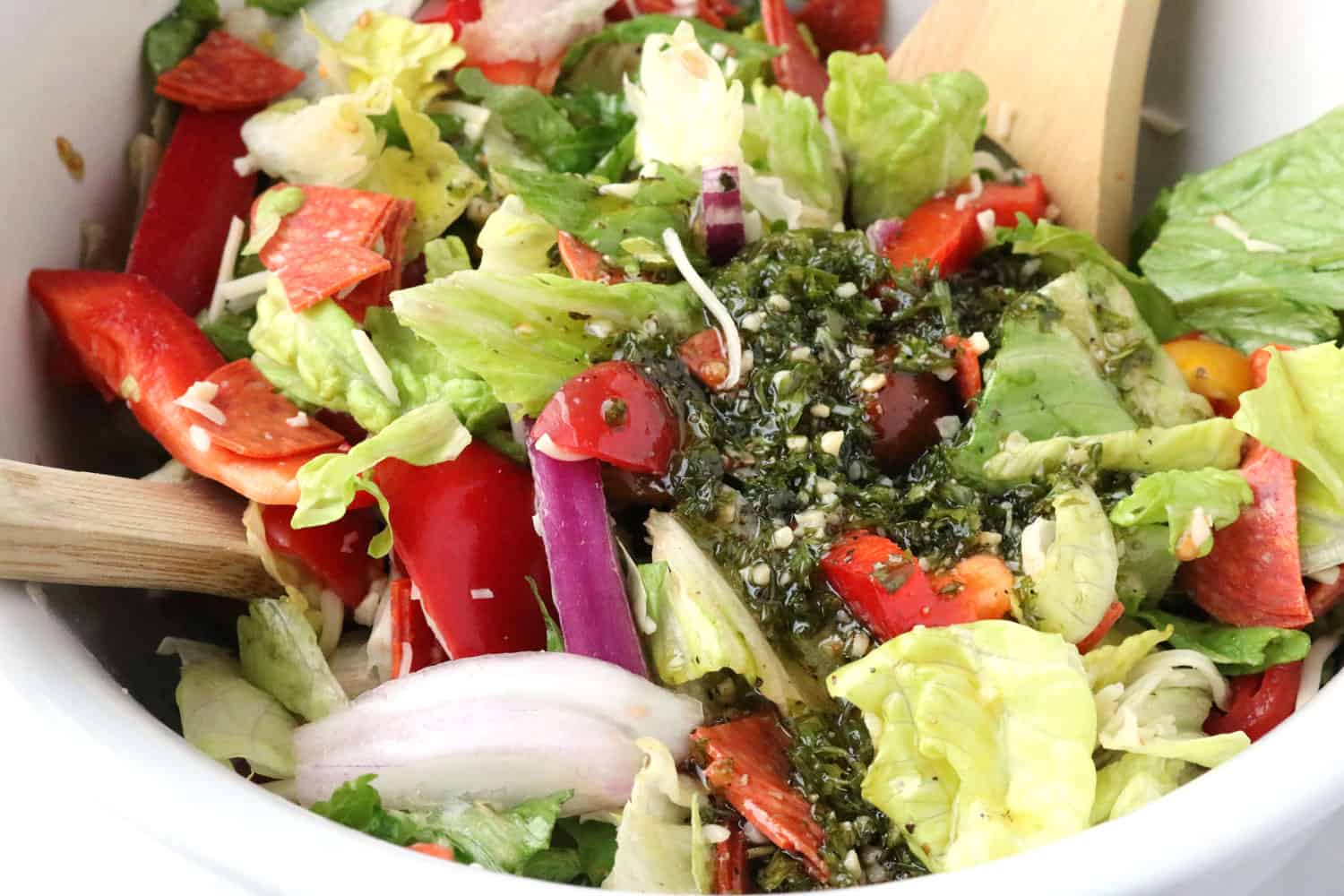 close-up of Italian salad with homemade Italian dressing poured on top.