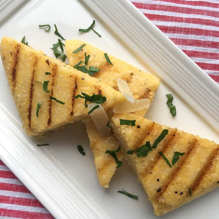 how to make polenta with pieces of grilled polenta on a white platter