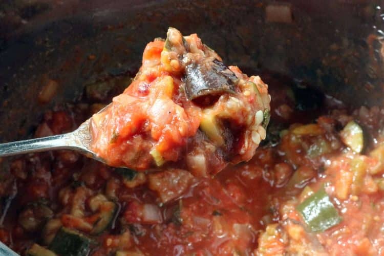 Cooked Instant Pot Eggplant Caponata with tomato paste stirred into the mixture.
