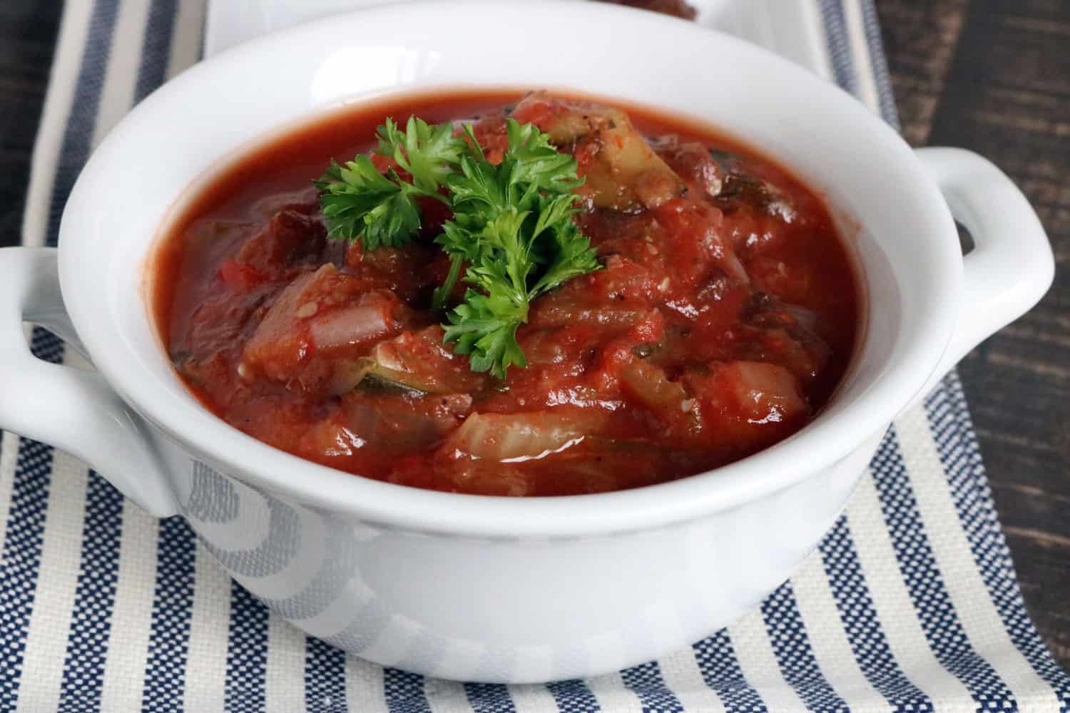 Close up view of Instant Pot Eggplant Caponata in white serving dish.