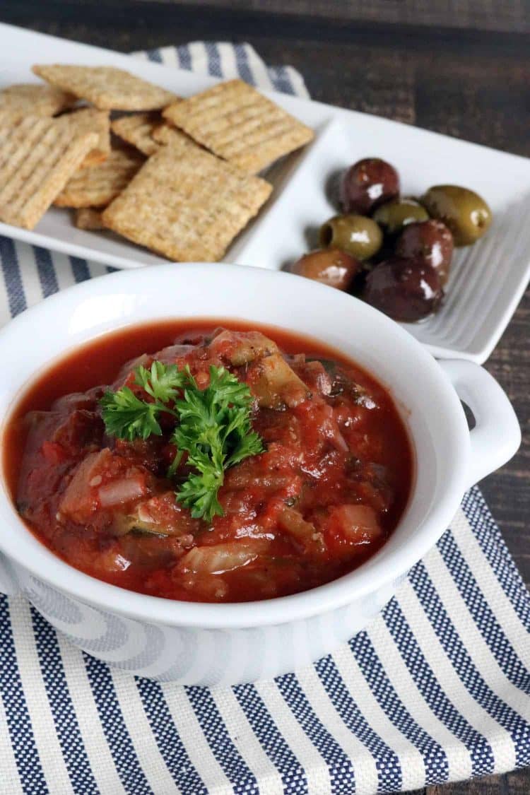 Over head view of Instant Pot Eggplant Caponata Appetizer with olives and crackers