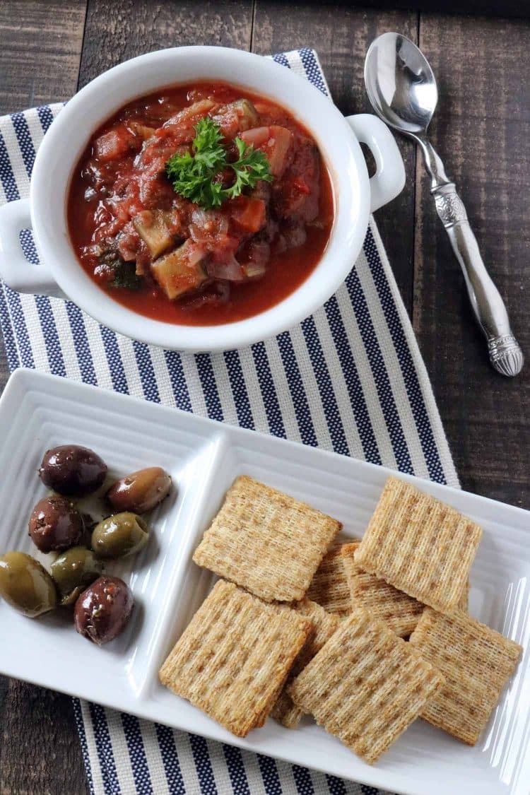 Overhead view of Instant Pot Eggplant Caponata served with crackers and olives.