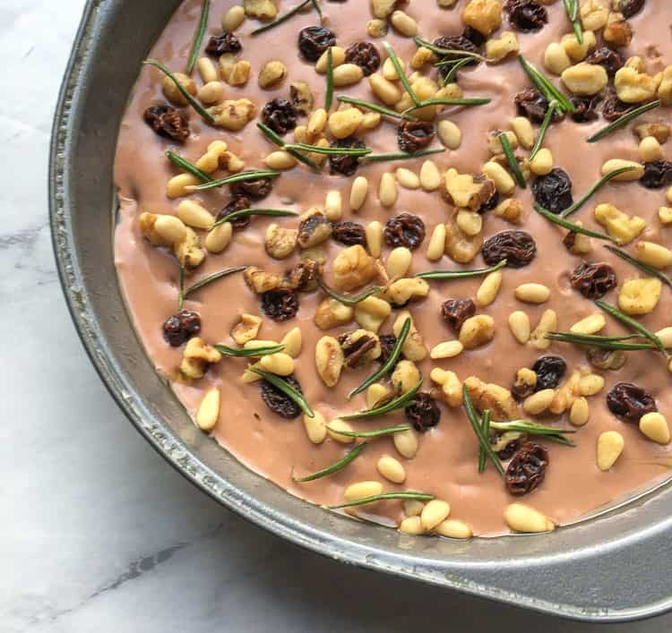 closeup of Castagnaccio batter in a baking dish before it has been cooked