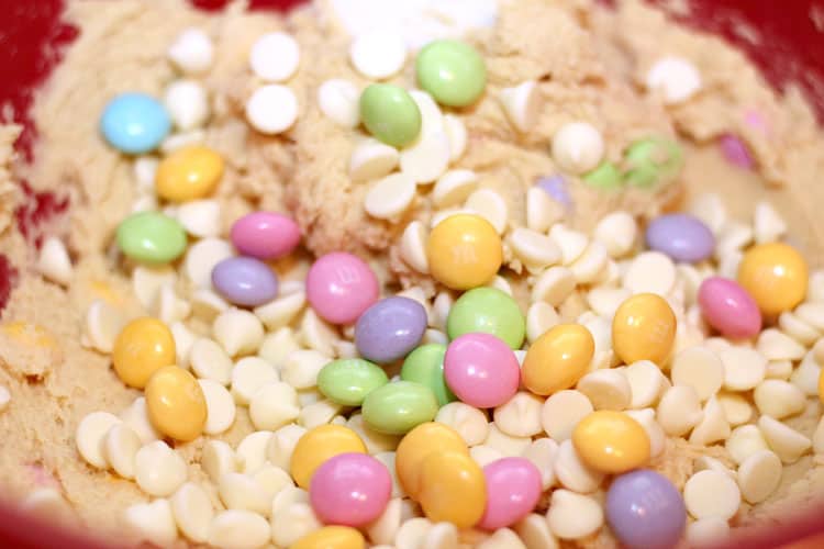 close up of spring cookies batter containing white chocolate chips and pastel candies