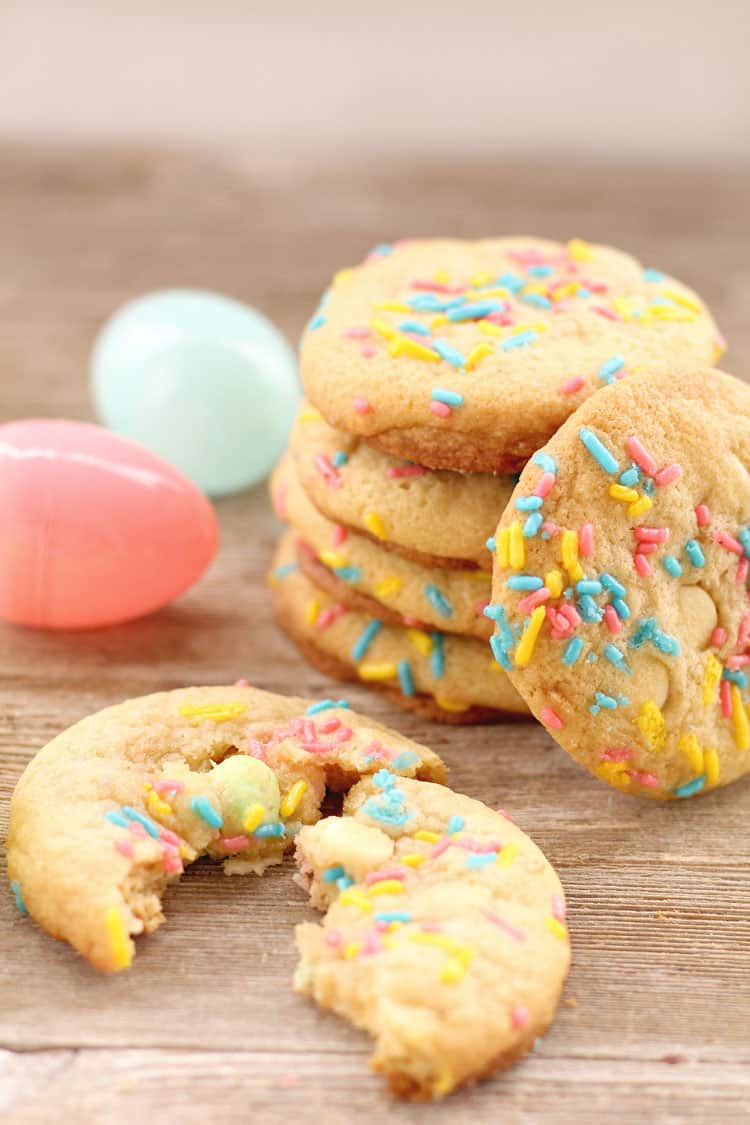 split spring cookie in front of stack of spring cookies next to easter eggs