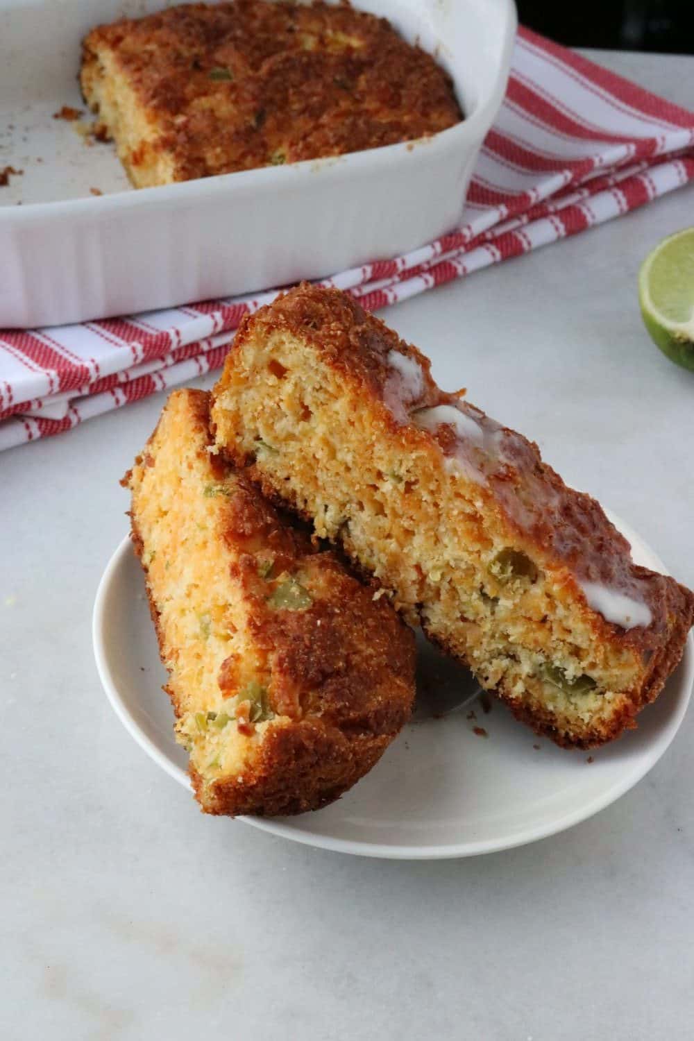 Mexican Corn Bread completed product. Two slices on white plate.