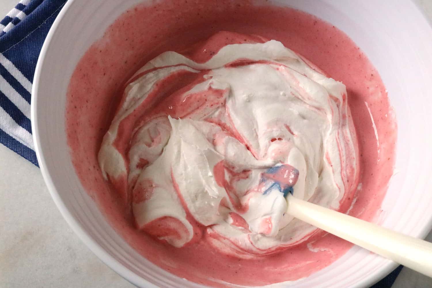 whipped topping being folded into the pie filling mixture