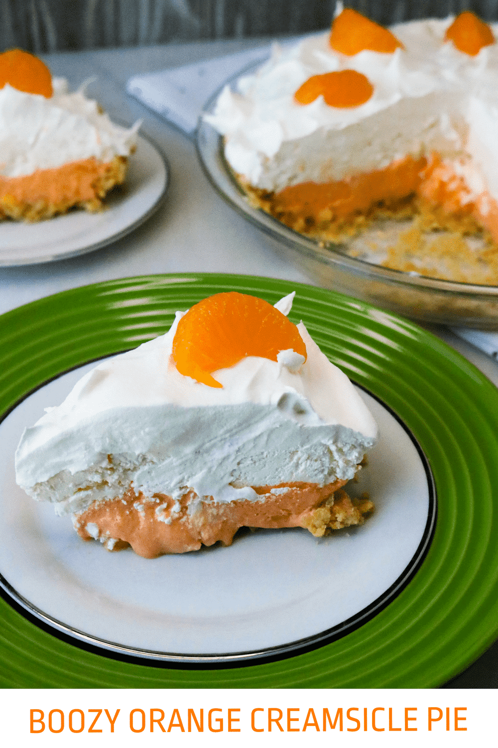 Boozy Orange Creamsicle Pie is the perfect combination of oranges and cream. The addition of vanilla-infused vodka puts a delicious adults-only twist on a classic childhood frozen treat. This is one fun and festive dessert that's sure to be a hit at any summertime celebration! #CreamsiclePie #nobake #boozydesserts #orange #creamsicle