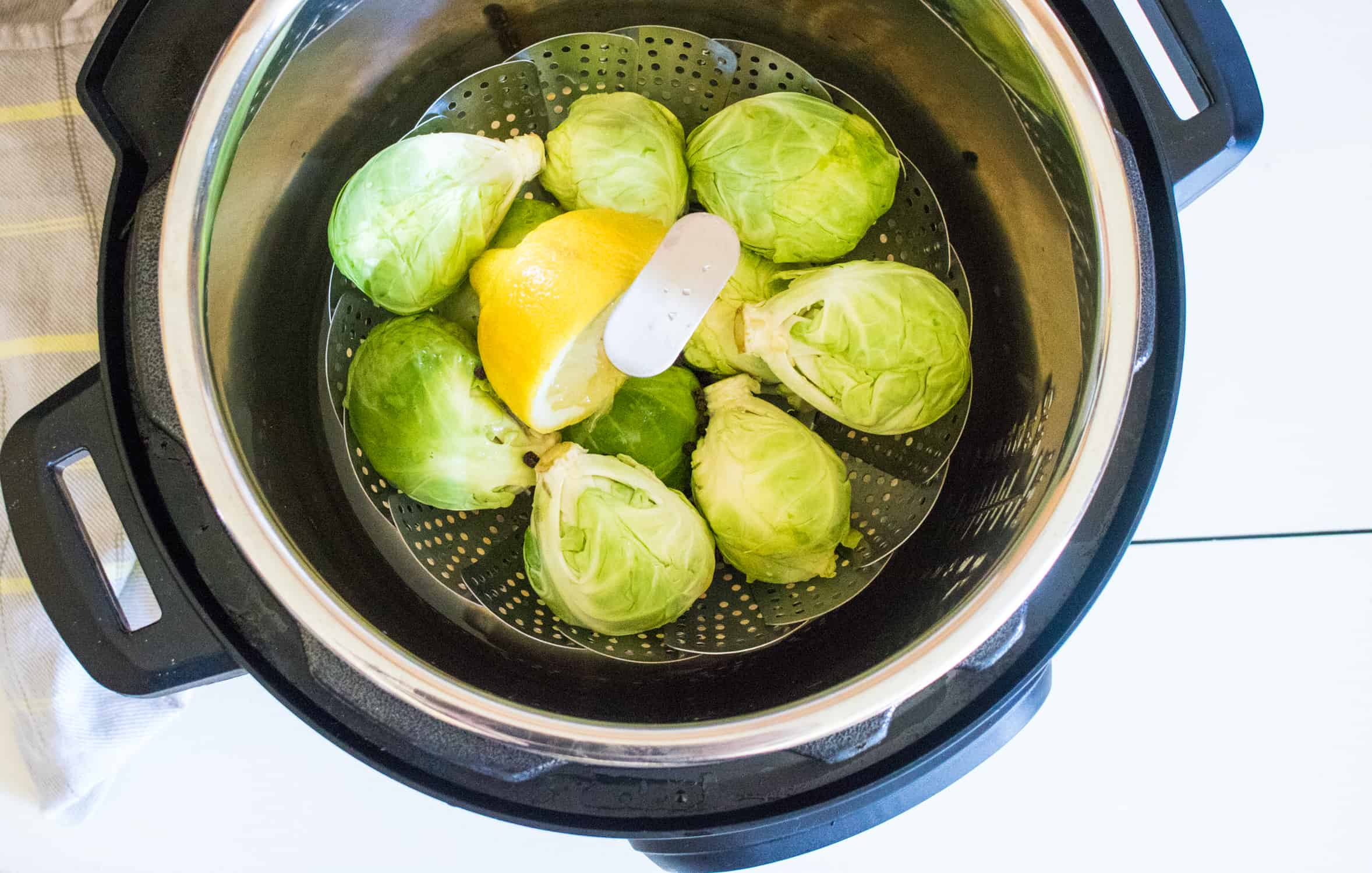 top-down view of the steamer basked filled with Brussels sprouts placed inside the Instant Pot