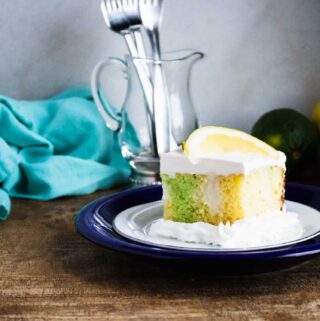 slice of lemon lime poke cake served on a blue plate