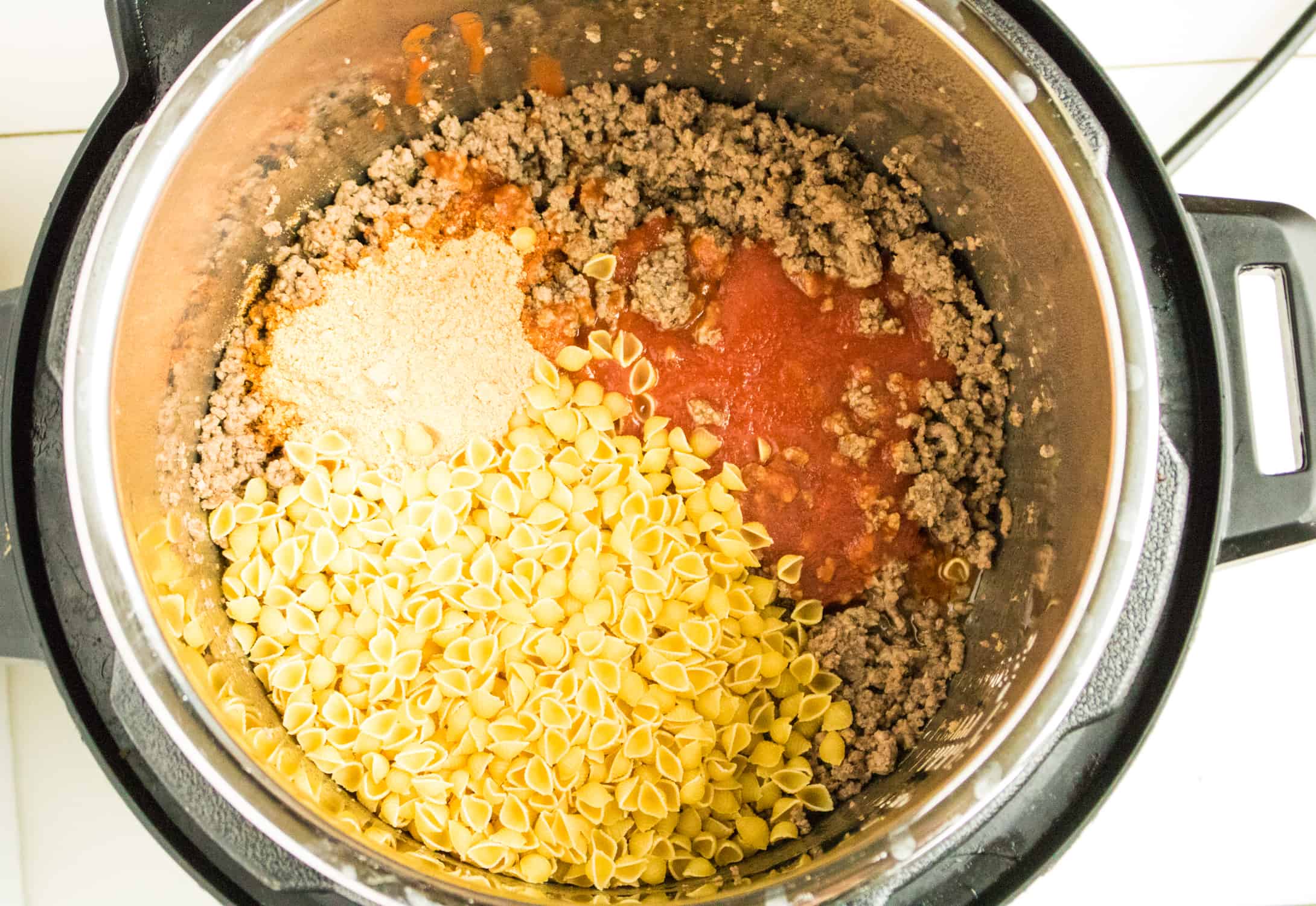Ground beef, pasta, seasoning and salsa in Instant Pot