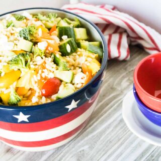 Summer Orzo Salad in a patriotic red white and blue design serving bowl