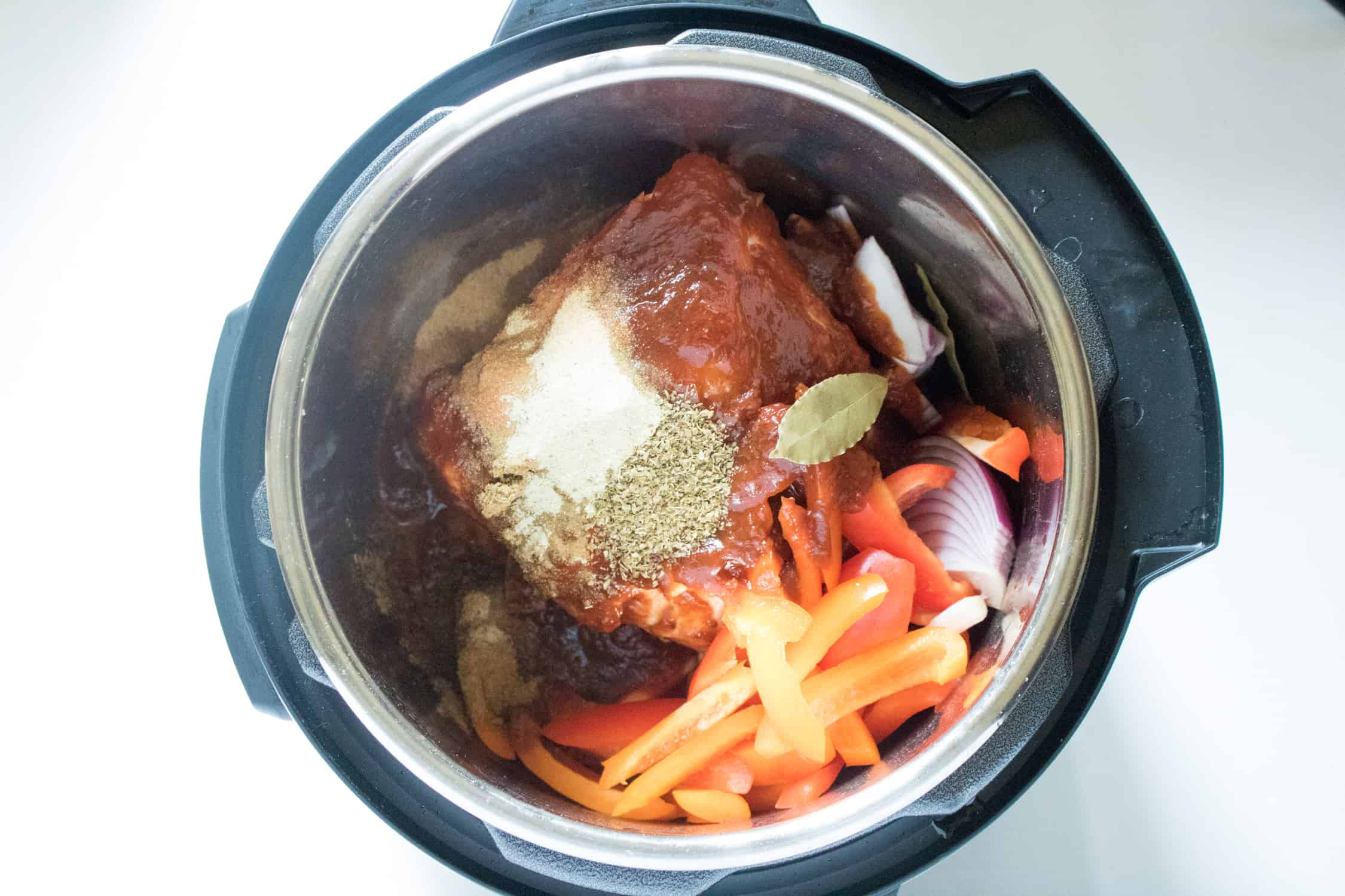 top-down view of all ingredients for Instant Pot Pork Carnitas inside the Instant Pot
