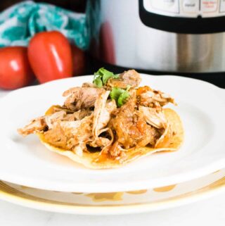 Instant Pot Pork Carnitas on a corn tortilla and garnished with cilantro