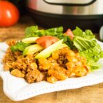 Permalink to: Instant Pot Taco Pasta — A New Take on Taco Tuesday Instant Pot Taco Pasta served on a white plate sitting in front of the Instant Pot and two tomatoes