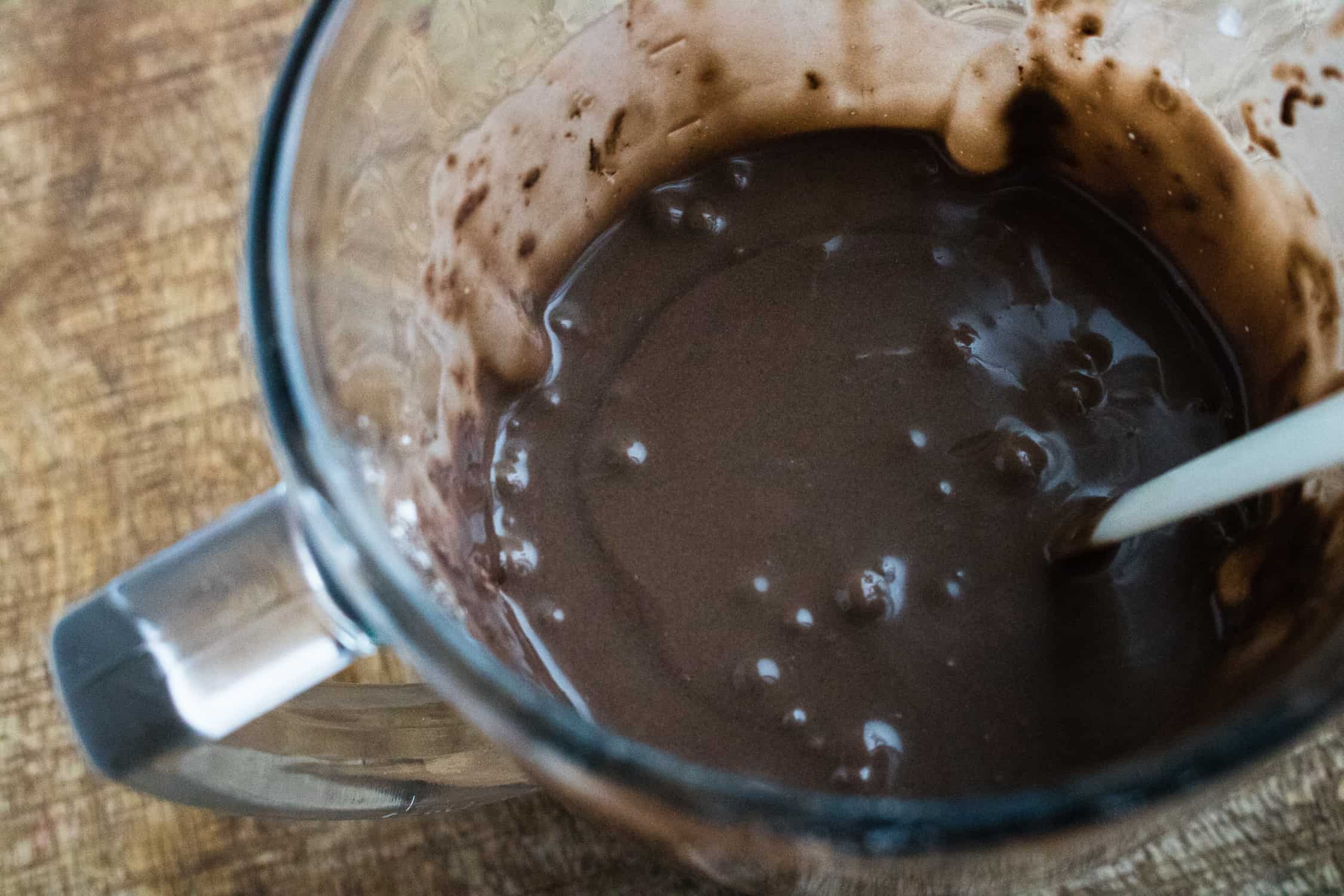 the ingredients for chocolate dessert crepes batter mixed together inside a blender