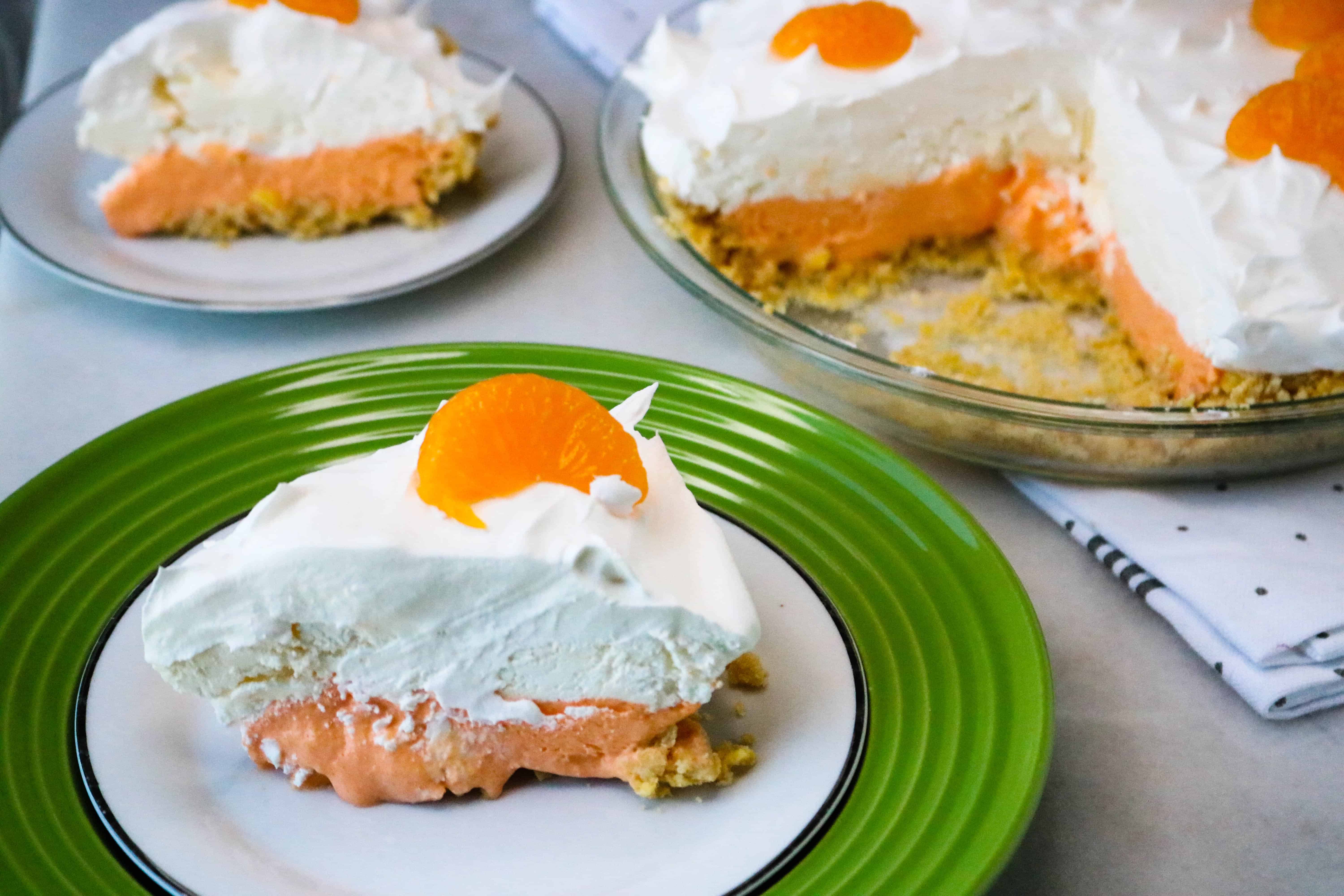 Boozy Orange Creamsicle Pie sliced and served on a plate.