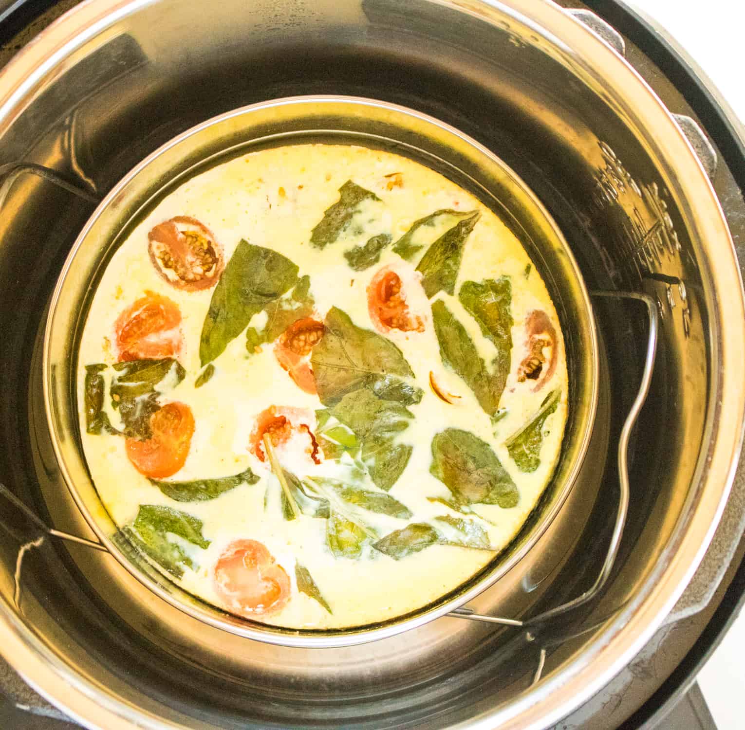 Top-down view of the cooked Caprese frittata inside the Instant Pot