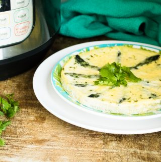 Instant Pot Asparagus Parmesan Frittata served on a blue print plate and garnished with parsley
