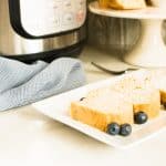 Permalink to: Instant Pot Pound Cake Recipe Slices of Instant Pot Pound Cake on a white serving tray and garnished with blueberries and powdered sugar