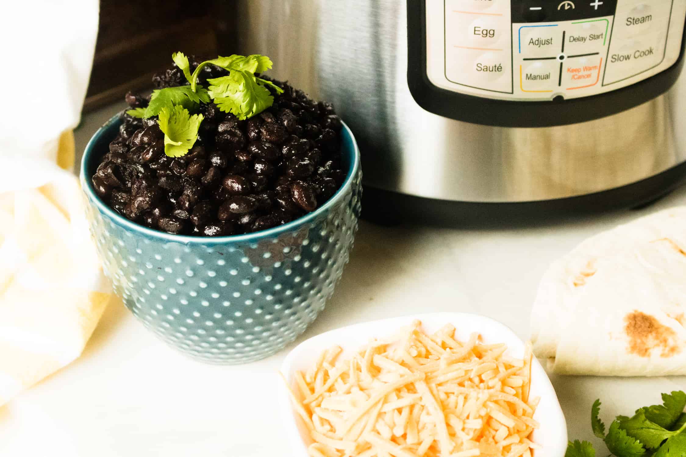 Cooked black beans in serving bowl with Instant Pot