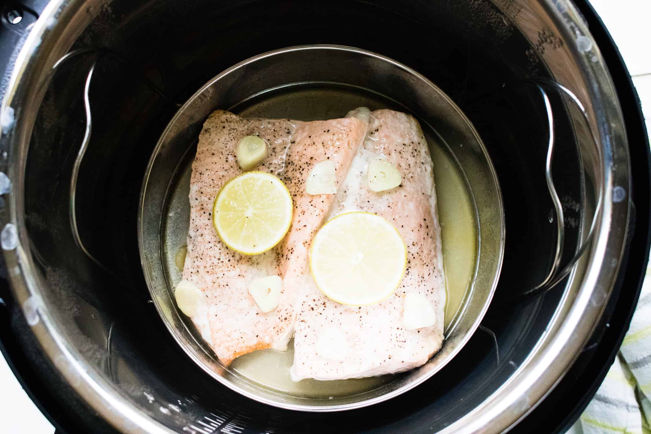 looking down into instant pot at completed instant pot lemon garlic salmon 