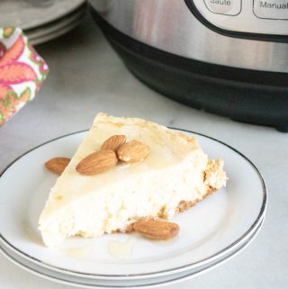 slice of Instant Pot Keto GF Cheesecake served on a white dessert plate