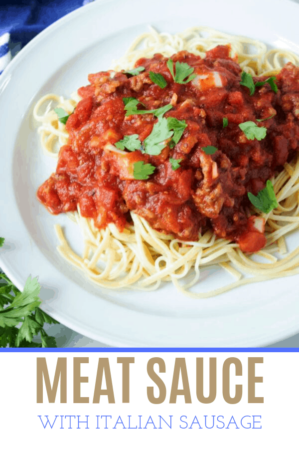 meaty pasta sauce on spaghetti served on a white plate