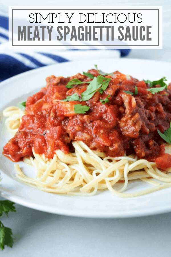 meaty pasta sauce on spaghetti served on a white plate