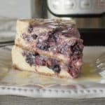 Permalink to: Instant Pot Blackberry Swirl Cheesecake Recipe One slice of Instant Pot Blackberry Swirl Cheesecake served on a square white plate