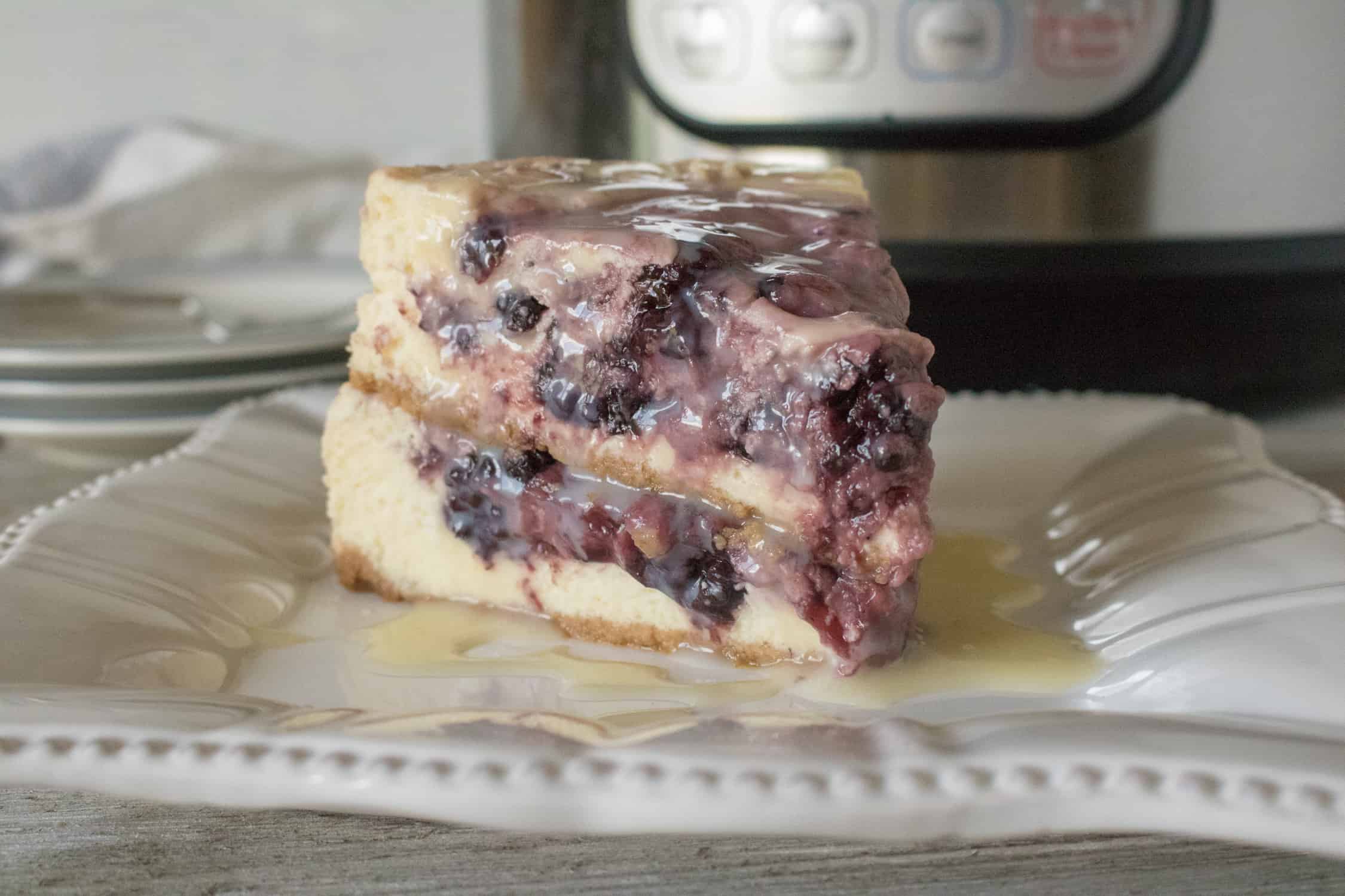 One slide of Instant Pot Blackberry Swirl Cheesecake served on a white plate
