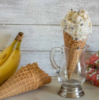 a scoop of banana chocolate chip no-churn ice cream served on a waffle cone