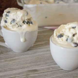 two servings of blueberry lemon no-churn homemade ice cream served in white ceramic mugs