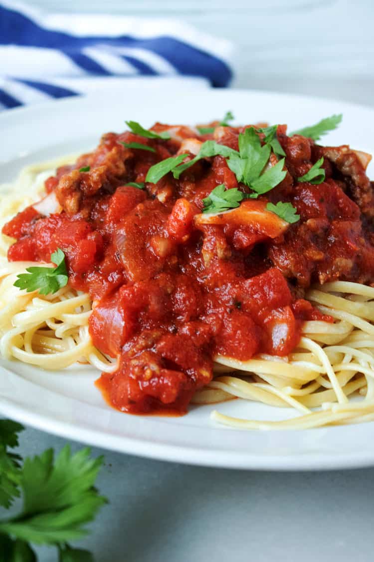 meat spaghetti sauce on top of pasta noodles